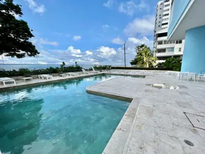 a swimming pool in a building with blue water at Oceanview Bocagrande Laguito Palmetto Sunset Building in Cartagena de Indias