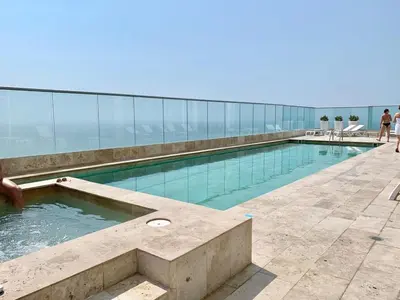 a swimming pool on top of a building at Oceanview Bocagrande Laguito Palmetto Sunset Building in Cartagena de Indias