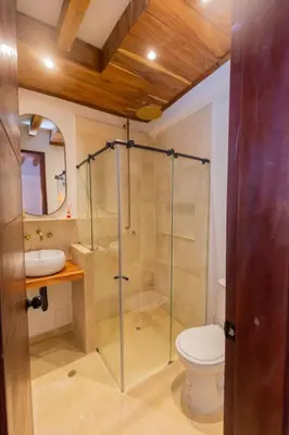 a bathroom with a glass shower and a toilet at Casa Bali Castillo View Private Pool & Rooftop, Near Historic Center in Cartagena de Indias