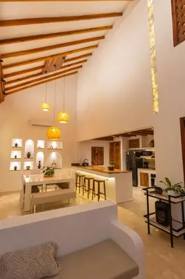 a kitchen and living room with a table and chairs at Casa Bali Castillo View Private Pool & Rooftop, Near Historic Center in Cartagena de Indias