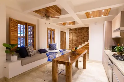 a living room with a couch and a table at Blue House Castillo View Private Jacuzzi & Colonial Balconies in Cartagena de Indias