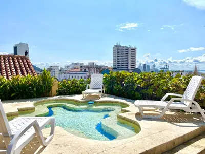a patio with two chairs and a small pool at Calamari Homes - El Porvenir 305 - Walled city in Cartagena de Indias