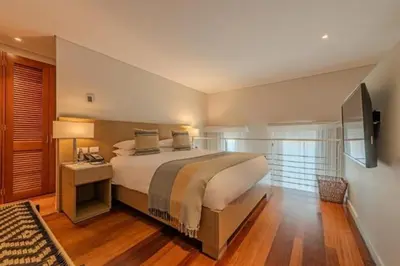 a bedroom with a large bed and a television at APARTAMENTO CON VISTA Al MAR in Cartagena de Indias