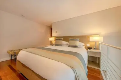 a bedroom with a large white bed with two pillows at APARTAMENTO CON VISTA Al MAR in Cartagena de Indias