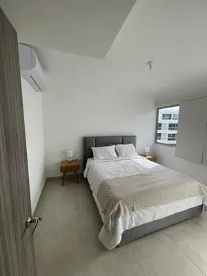 a white bedroom with a large bed and a window at An apartment in Serena del Mar in Serena del Mar