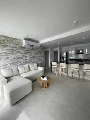 a living room with a white couch and a table at An apartment in Serena del Mar in Serena del Mar