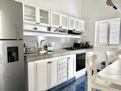 a kitchen with white cabinets and a blue tile floor at by Calamari Homes-Plaza Bolivar Penthouse Sea view in Cartagena de Indias
