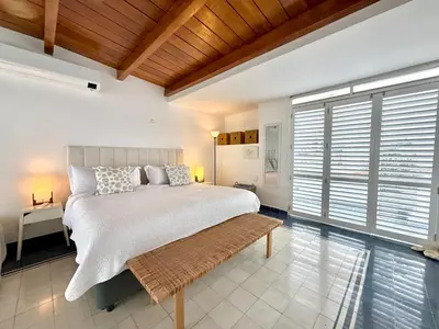 a bedroom with a large bed and a large window at by Calamari Homes-Plaza Bolivar Penthouse Sea view in Cartagena de Indias