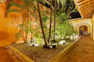 a hallway with palm trees in a building at Reve hotel in Cartagena de Indias