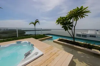 a swimming pool with a view of the ocean at Exclusivo apartamento en Cielo Mar - Américas 609 in Cartagena de Indias