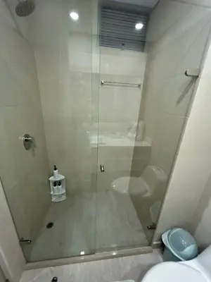 a bathroom with a glass shower with a toilet at Exclusivo apartamento en Cielo Mar - Américas 609 in Cartagena de Indias