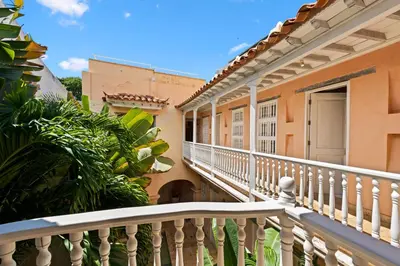 a balcony of a building with a white railing at Upper Hotel in Cartagena de Indias