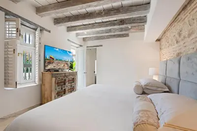 a bedroom with a large bed and a tv at Upper Hotel in Cartagena de Indias