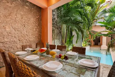a dining room with a table with fruit on it at Upper Hotel in Cartagena de Indias