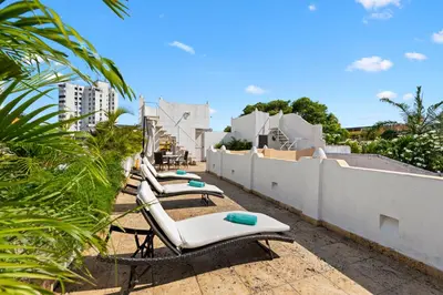 a row of lounge chairs on the roof of a building at Upper Hotel in Cartagena de Indias
