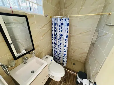 a small bathroom with a toilet and a sink at Apto con piscina a 7 min caminando de playa Bello Horizonte in Santa Marta