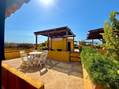 a patio with a table and chairs and a building at by Calamari Homes - El Porvenir 402 walled city in Cartagena de Indias