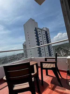 a balcony with two chairs and a table on a balcony at Apartamento amoblado, cómodo y cerca de lo mejor de la ciudad in Cartagena de Indias