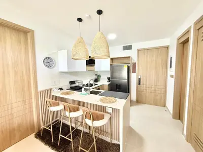 a kitchen with a counter and stools in it at Baia Krystal P4, 1A in Cartagena de Indias