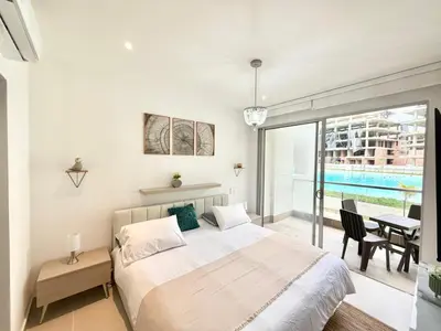a bedroom with a bed and a table and a balcony at Baia Krystal P4, 1A in Cartagena de Indias