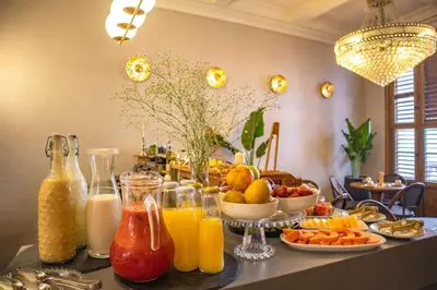 a breakfast table with fruits and vegetables and juice at Hotel Casa Bianca by Faranda Boutique in Cartagena de Indias