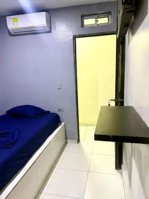 a small room with a bed and a table at Hotel las nubes Barranquilla in Barranquilla