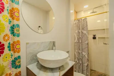 a bathroom with a large bowl sink and a mirror at Almería Apt, Cozy Studio withTerrace Near Old Town in Cartagena de Indias