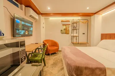 a bedroom with a bed and a desk and a tv at Almería Apt, Cozy Studio withTerrace Near Old Town in Cartagena de Indias
