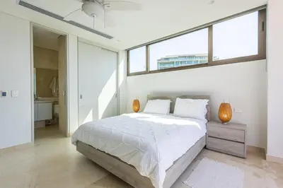a white bedroom with a large bed and a window at 4BR Caribbean Deluxe Villa 3C in Cartagena de Indias