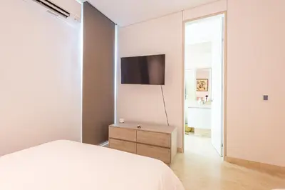 a bedroom with a bed and a tv on a wall at 4BR Caribbean Deluxe Villa 3C in Cartagena de Indias