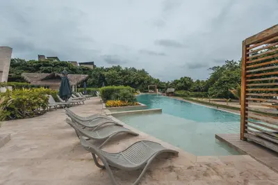 a swimming pool with lounge chairs in a resort at 4BR Caribbean Deluxe Villa 3C in Cartagena de Indias
