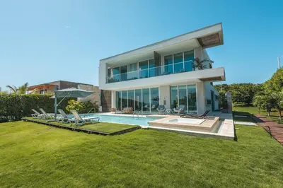 a large house with a swimming pool in the yard at Brand new 4BR Villa at Calablanca in Cartagena de Indias