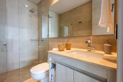 a bathroom with a sink and a toilet and a shower at 4BR Seaview Apartment at Calablanca D5 in Cartagena de Indias