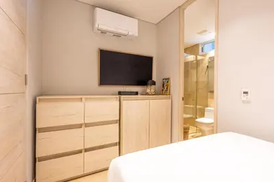 a bedroom with a flat screen tv on a wall at 4BR Seaview Apartment at Calablanca D5 in Cartagena de Indias