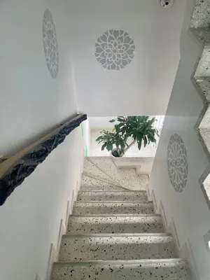 a staircase in a building with a plant at Almería Apt, Stylish Modern Studio Near Centro in Cartagena de Indias