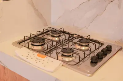 a stove top with pots and pans on it at Almería Apt, Stylish Modern Studio Near Centro in Cartagena de Indias