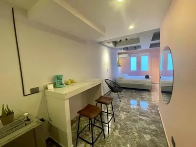 a room with two stools and a counter in a room at Almería Apt, Stylish Modern Studio Near Centro in Cartagena de Indias