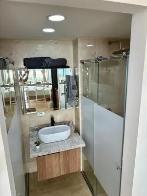 a bathroom with a sink and a glass shower at Cartagena Beach - Sea View - Airport 5 min in Cartagena de Indias