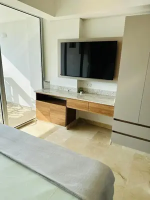 a living room with a television and a bed at Cartagena Beach - Sea View - Airport 5 min in Cartagena de Indias