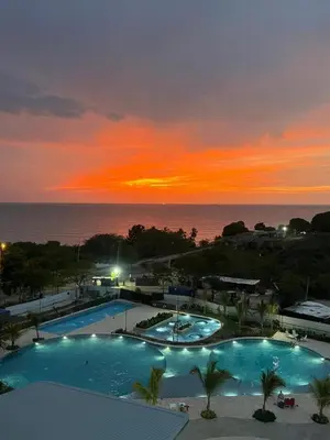a view of two swimming pools at sunset at Apartamento con vista al mar y acceso a la playa in Santa Marta