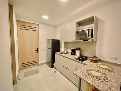 a kitchen with a refrigerator and a counter top at Apartamento con vista al mar y acceso a la playa in Santa Marta