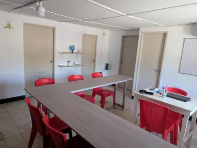 a conference room with a long table and red chairs at English power Exotic point in Barranquilla