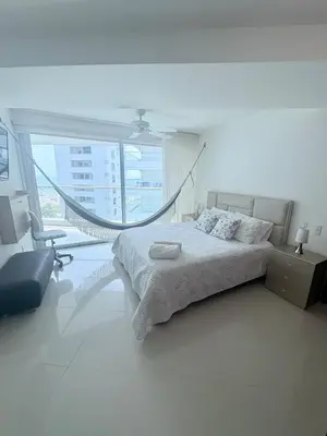 a bedroom with a bed and a hammock in it at Apartamento en Morros in Cartagena de Indias