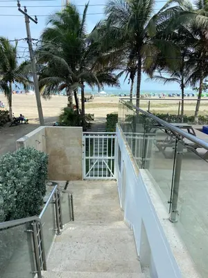 a view of a beach from a balcony with palm trees at Apartamento en Morros in Cartagena de Indias