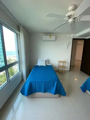a bedroom with a blue bed and a ceiling fan at Apartamento en Morros in Cartagena de Indias