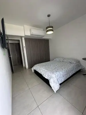 a bedroom with a bed and a tv in it at Apartamento cómodo en Conjunto residencial Castelo Cartagena in Cartagena de Indias