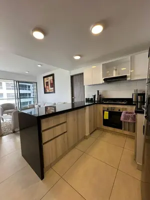 a kitchen with a black counter top in a room at Apartamento cómodo en Conjunto residencial Castelo Cartagena in Cartagena de Indias
