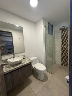 a bathroom with a toilet and a sink and a shower at Apartamento cómodo en Conjunto residencial Castelo Cartagena in Cartagena de Indias