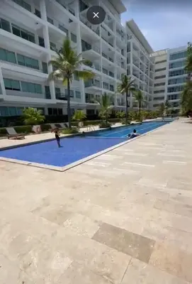 a person standing in front of a large building at Exclusivo Apartamento con playa y piscinas Morros Cartagena in Cartagena de Indias