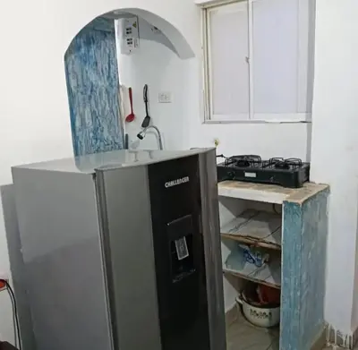 a kitchen with a sink and a refrigerator at Casamar sol caribe in Cartagena de Indias